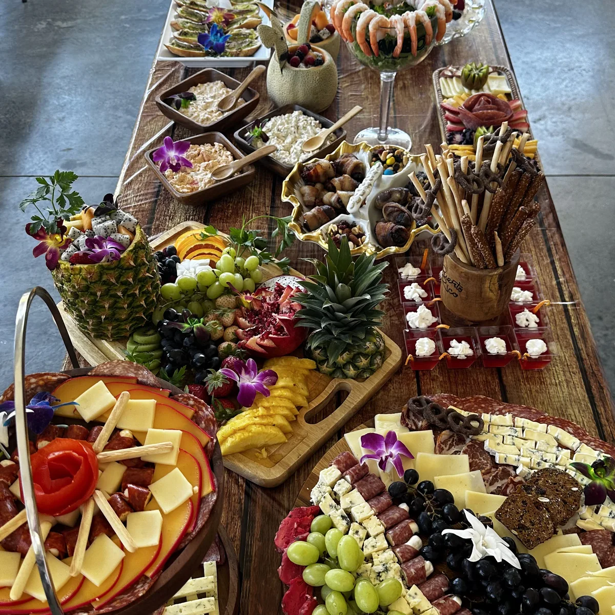 An abundant Finca America table with charcuterie, fruit and composed bites