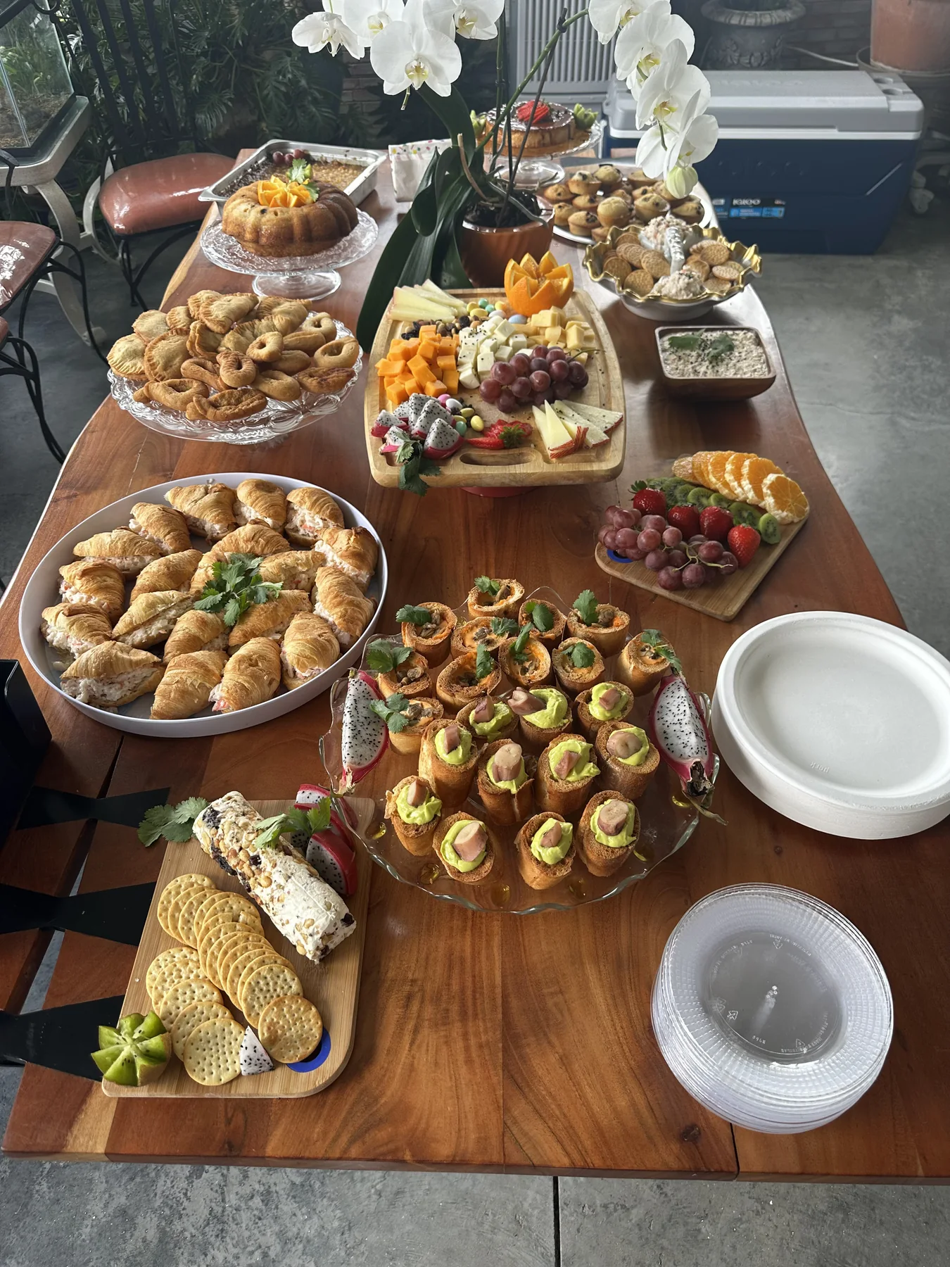 Brunch table with savory pastries, fruit, cheeses and baked selections