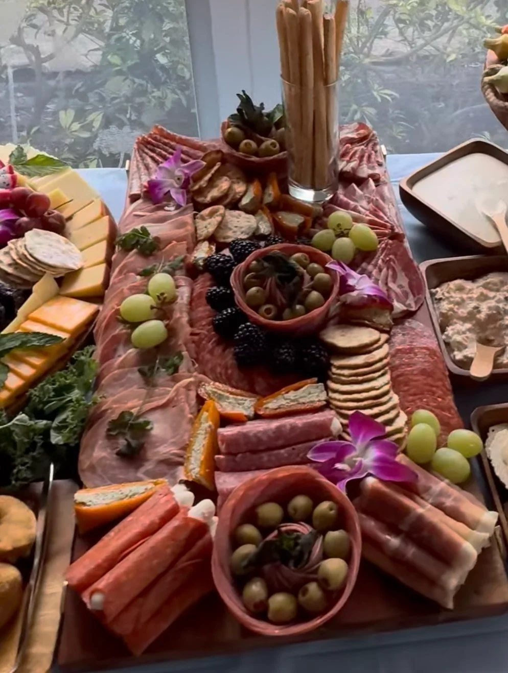 Close view of a Finca America grazing table with charcuterie, cheeses and fruit